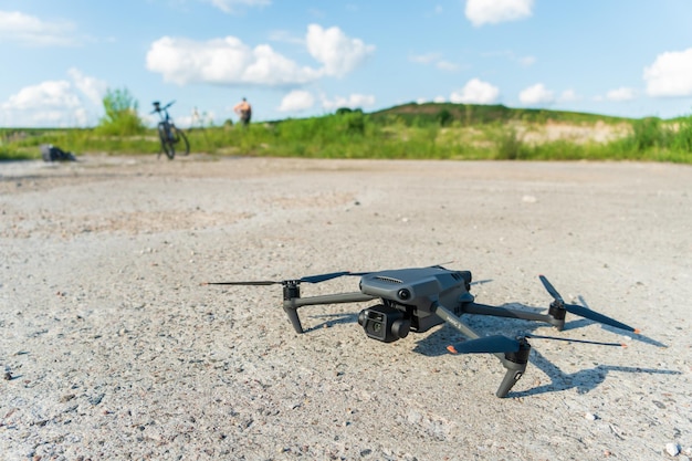 Grodno Belarus June 10 2022 The new modern DJI MAVIC 3 drone lies on a concrete surface with the screws turned off and is preparing for the first takeoff The best drone for photographer