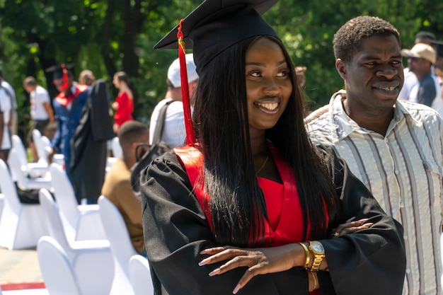 Grodno Belarus June 2021 Graduation of medical University students AfricanAmerican students receive diplomas Joyful graduate students on the street on a sunny day