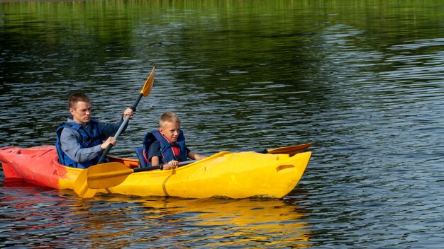 Grodno belarus june 2021 kayaking on the river on calm water on\
a warm sunny day young people are kayaking the concept of active\
recreation and healthy lifestyle