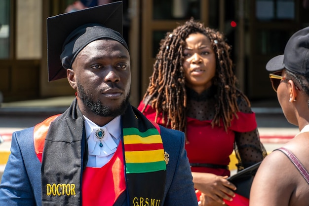 Grodno belarus june 2021 portrait of an africanamerican student\
in a tuxedo at the graduation ceremony graduation from\
university