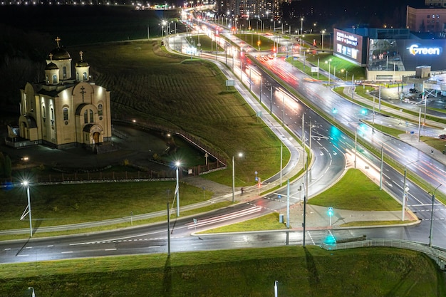 Grodno Belarus June 2021 Top view of a major road junction in the city at night The movement of cars in the night city Light from vehicles and lanterns on roads and streets