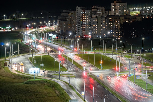 Grodno Belarus June 2021 Top view of a major road junction in the city at night The movement of cars in the night city Light from vehicles and lanterns on roads and streets