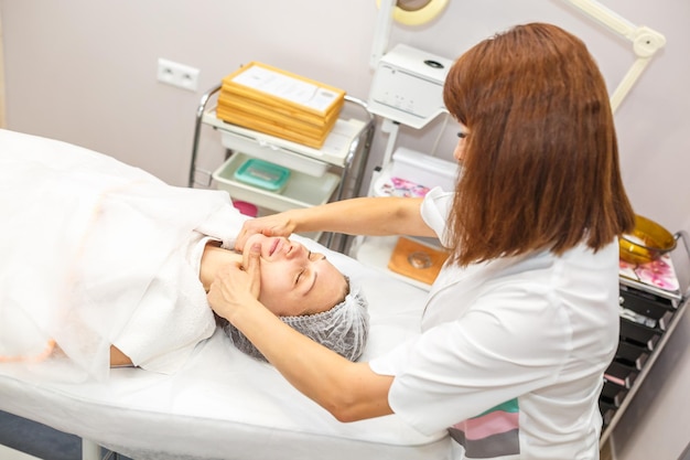 GRODNO BELARUS MAY 2018 woman doing facial massage at the beauty salon