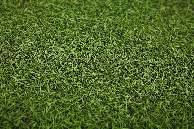 Groen kunstgras voetbalveld. de groene achtergrond.