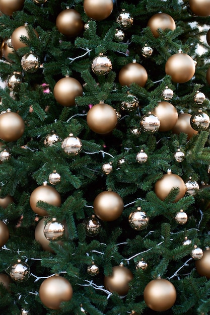 Broek Lao lekkage Groene kerstboom versierd met gouden ballen. | Premium Foto