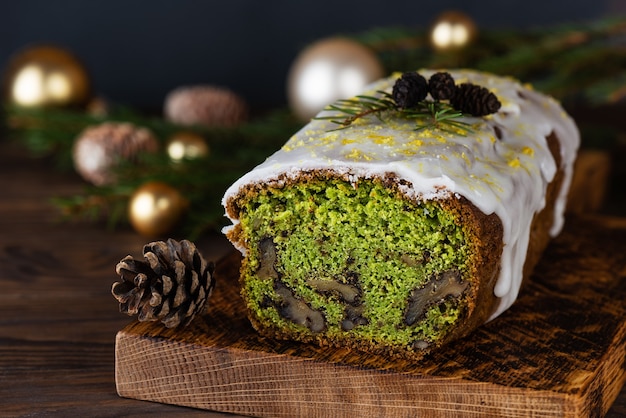 Groene kerstmuffin met spinazie, walnoot en citroen met kerstballen en dennenappels