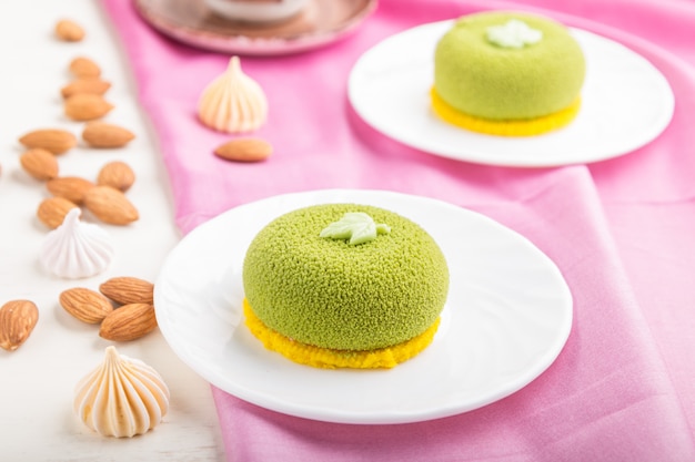 Groene mousse cake met pistache room en een kopje koffie. zijaanzicht