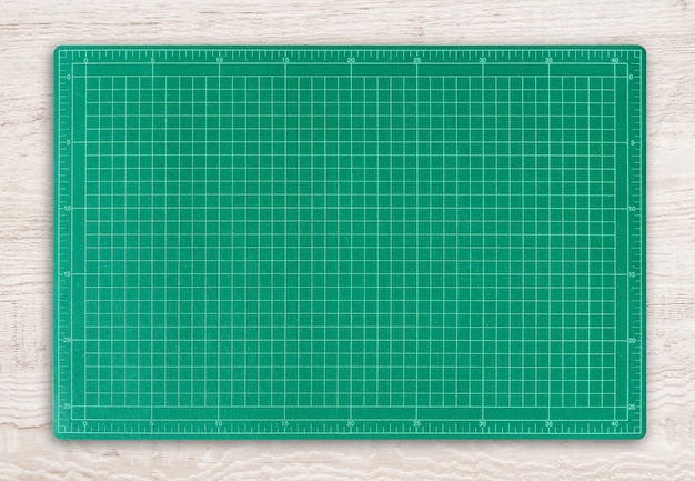 Foto groene scherpe mat op houten textuurachtergrond.