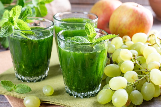 Groene Smoothie met gezonde groenten en fruit ingrediënten op een houten tafel. Gezond voedselconcept