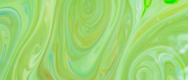 Groene vloeibare kunst achtergrond. Vloeibaar abstract patroon met UFO groen. Marmeren textuur van vloeibaar oppervlak. Vloeiende kunst