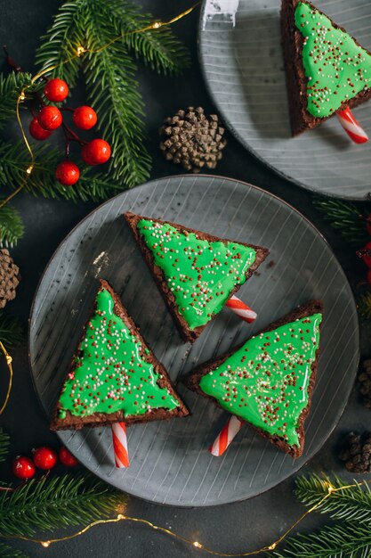 Groene zoete kerstboom gemaakt van chocolade brownie. Leuk idee voor kinderen voor kerstdessert