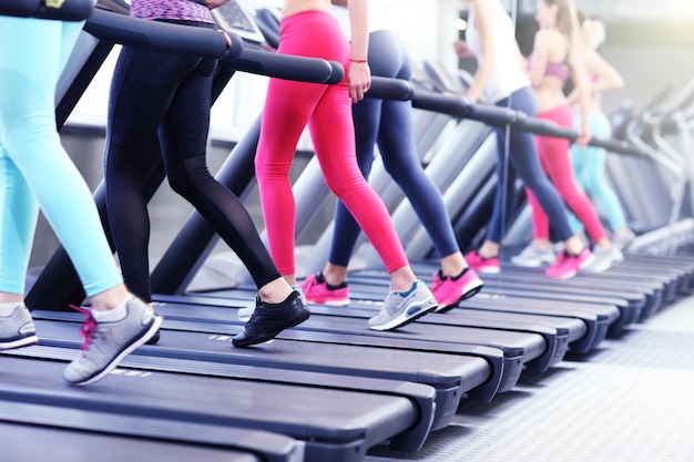 Foto groep fitte vrouwen die trainen op de loopband in de sportschool