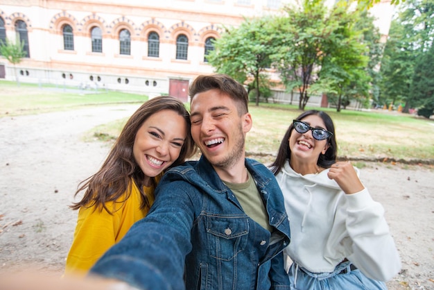 Groep gelukkige vrienden die samen een selfie nemen in een park