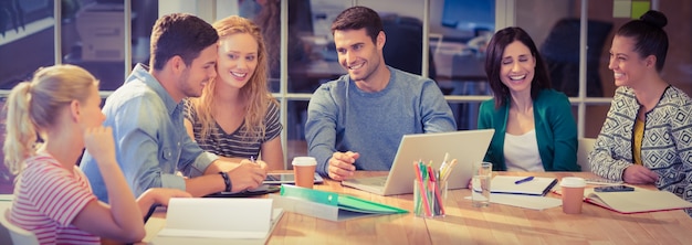 Groep jonge collega's met behulp van laptop