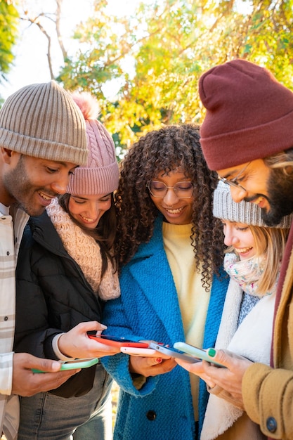 Foto groep jonge multi-etnische vrienden die buiten mobiele telefoons gebruiken mensen die verslaafd zijn aan technologie