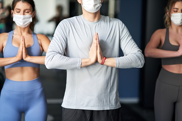 groep mensen die in een sportschool traint en maskers draagt vanwege covid-19