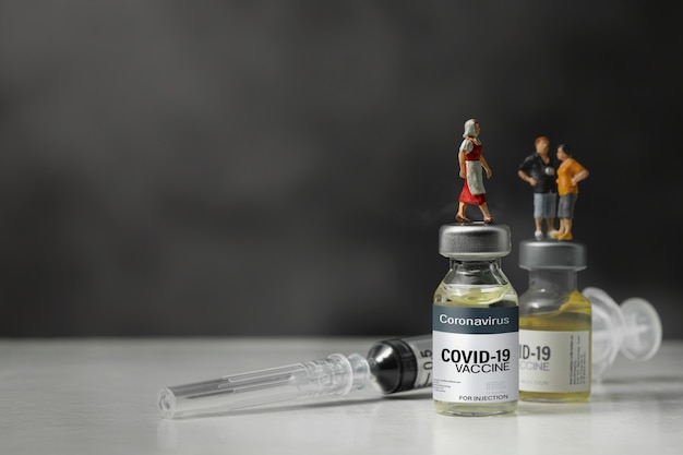 Groep mensen die zich op het vaccinflesje van het Coronavirus bevinden