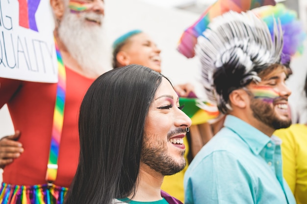 Groep mensen met regenboogvlaggen en spandoeken tijdens gay pride-evenement