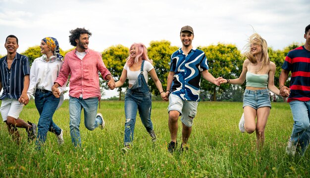 Groep multi-etnische tieners die tijd doorbrengen buiten op een picknick in het park