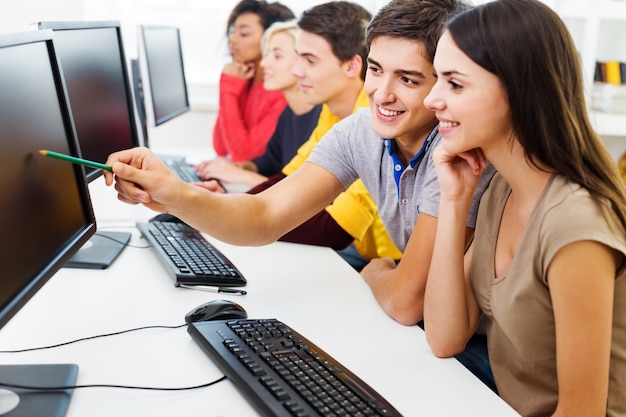 Groep studenten met computers bij les in klaslokaal