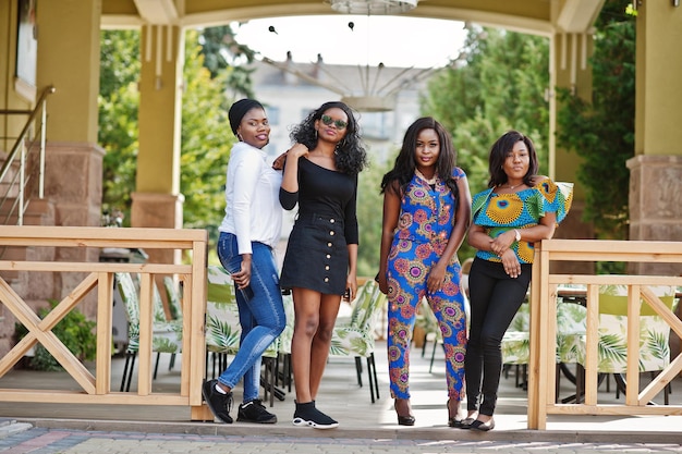 Groep van vier Afro-Amerikaanse meisjes poseerde buiten tegen het zomerterras van het stadsrestaurant