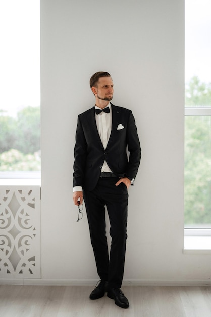 Groom in a black suit with a bow