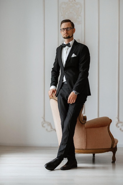 Groom in a black suit with a bow