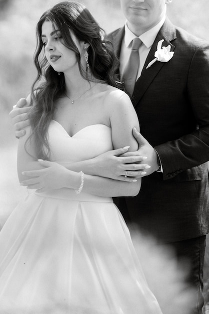 The groom and the bride are walking in the forest