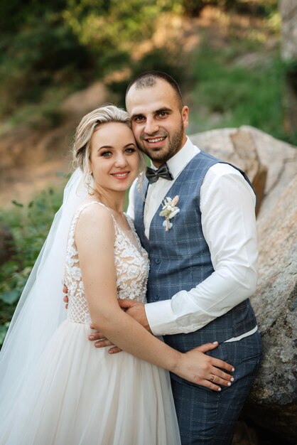 The groom and the bride are walking in the forest