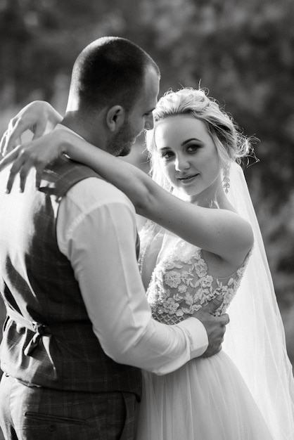 The groom and the bride are walking in the forest