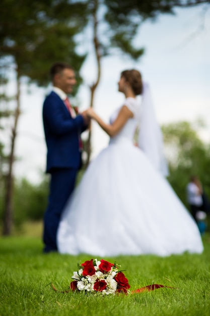 The groom the bride on the background of the bouquet