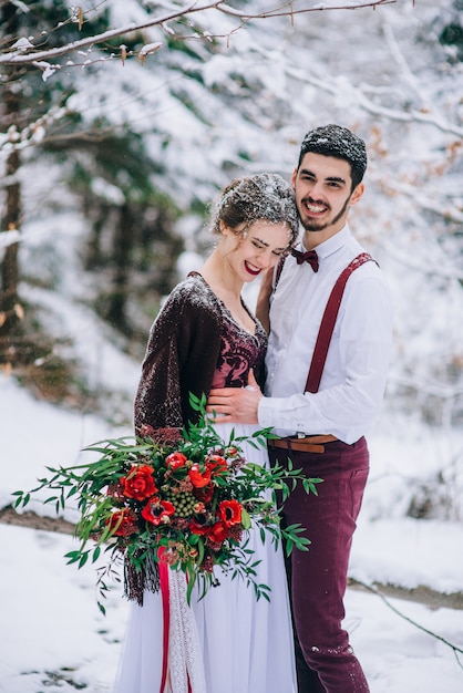 Groom and bride in the mountains Carpathians