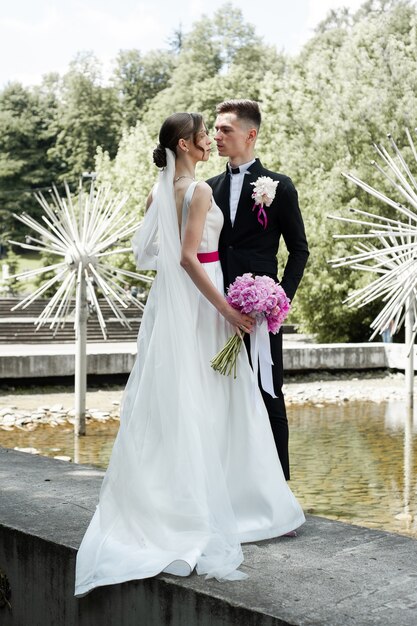 Groom and bride posing outdoor