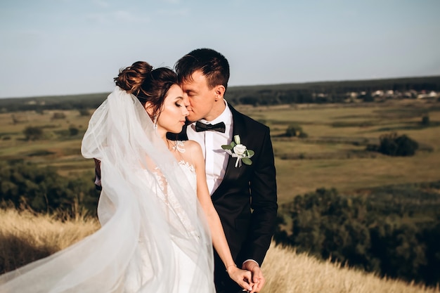 Groom and bride posing outside