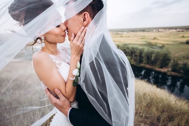 Groom and bride posing outside