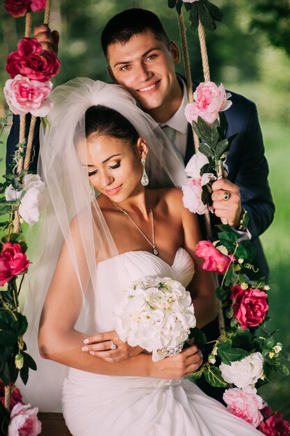 Groom and bride on swing