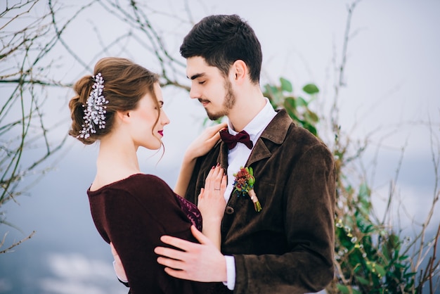 Groom in a brown and bride in the mountains Carpathians