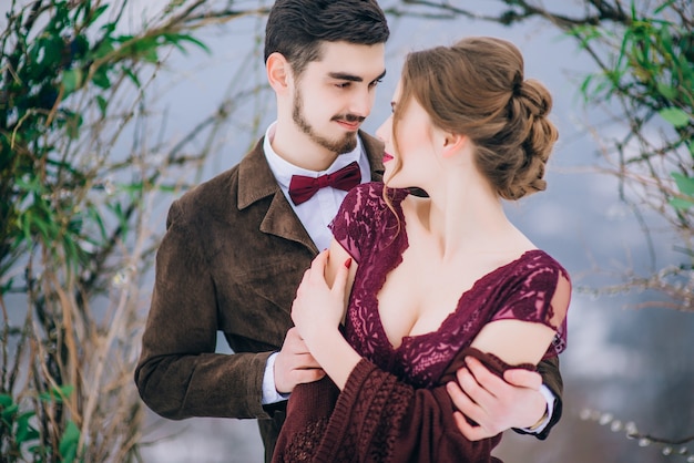 Groom in a brown and bride in the mountains Carpathians