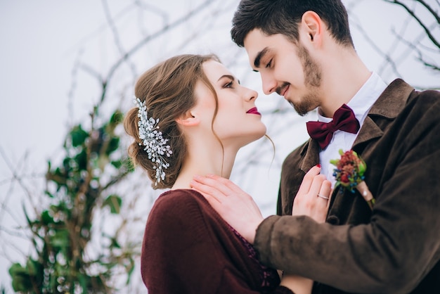 Groom in a brown and bride in the mountains Carpathians