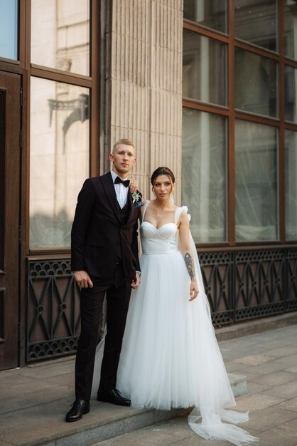 The groom in a brown suit and the bride in a white dress