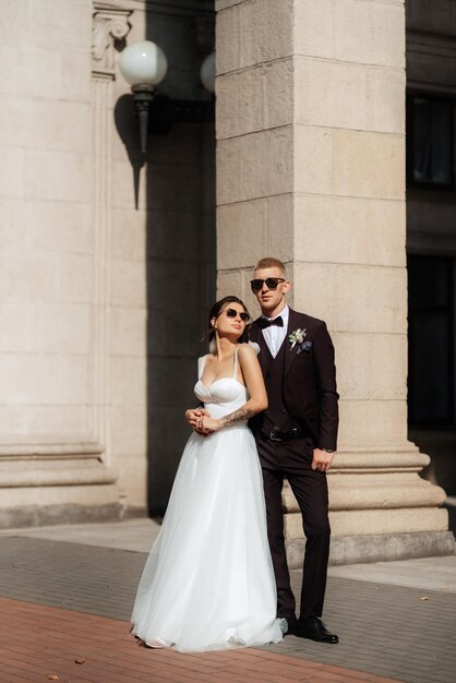 The groom in a brown suit and the bride in a white dress