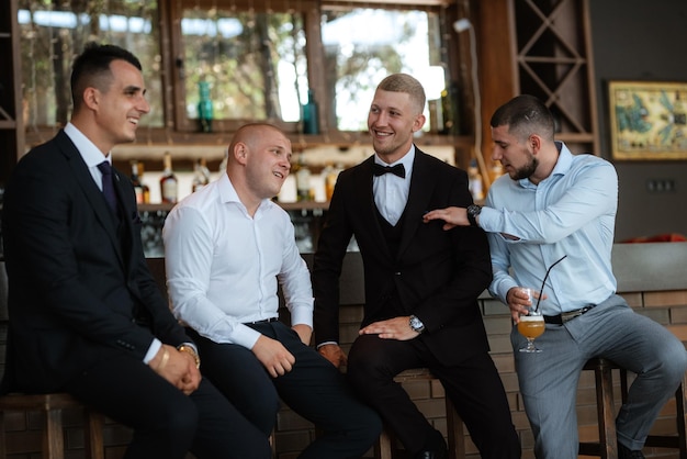 Groom in a brown suit and his friends