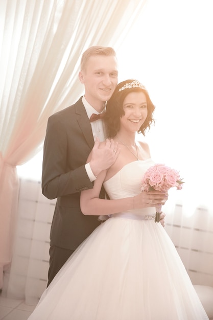 Groom embraces the bride after the wedding ceremony. photo with copy space