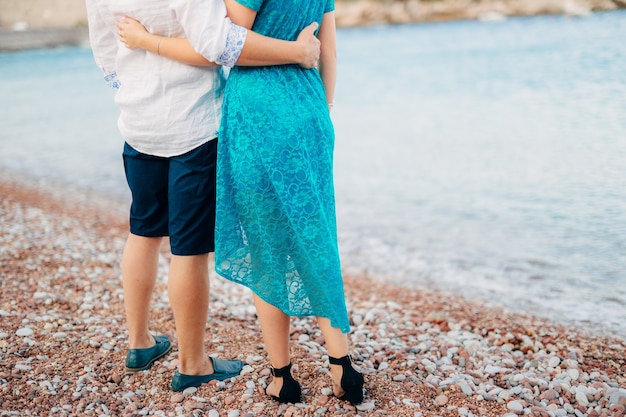 The groom embraces the bride on the beach wedding in montenegro