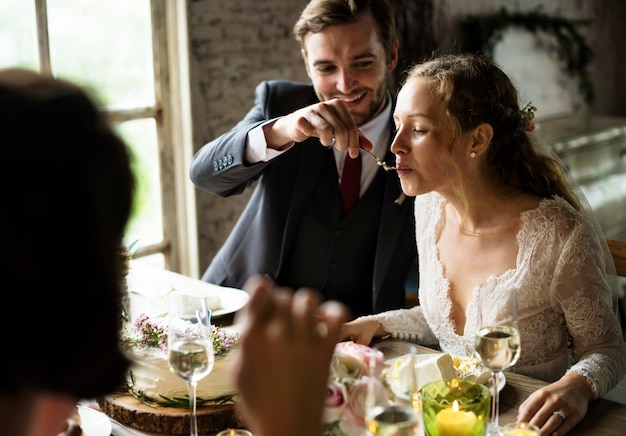 The groom feeding cake to the bride