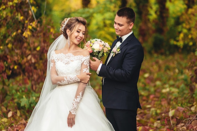 The groom gently caresses the bride's hand The bride closed her eyes A wedding walk in the forest