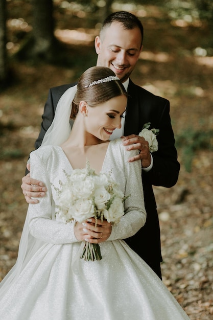 groom gently embracing his bride