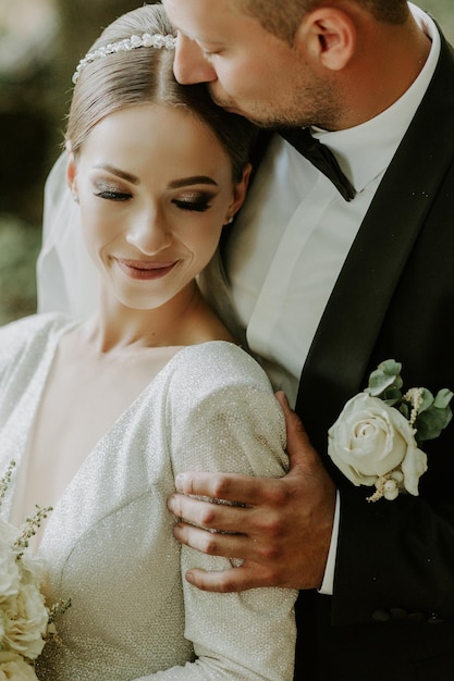 groom gently embracing his bride