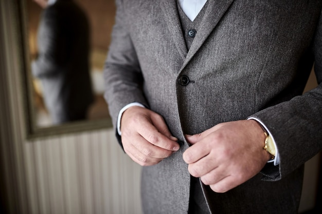 Groom getting ready in the morning before wedding ceremony