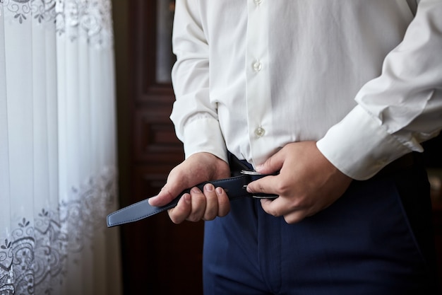 Groom getting ready in the morning before wedding ceremony